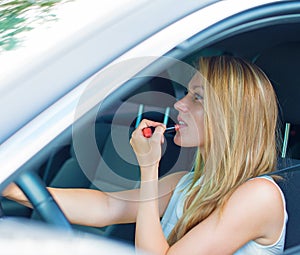 Woman applying make-up while driving car.