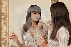 Woman applying makeup