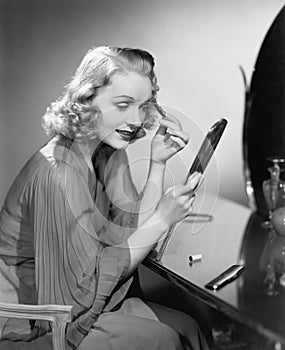 Woman applying makeup