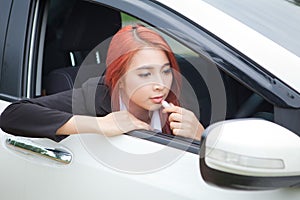 Woman applying makeup while in the car