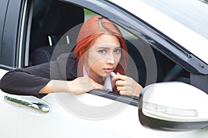 Woman applying makeup while in the car