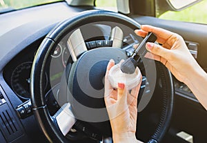Woman is applying makeup in the car. Girl with face powder behind the wheel. Dangerous situation on the road. Possibility of