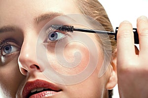 Woman applying mascara