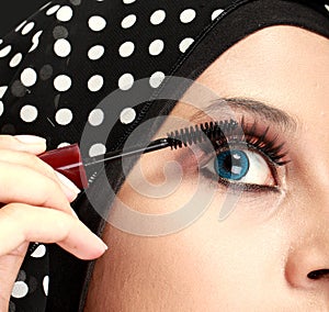 Woman applying mascara