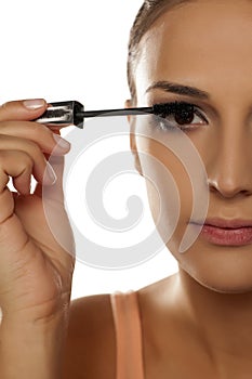 Woman applying mascara