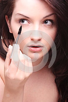 Woman applying mascara