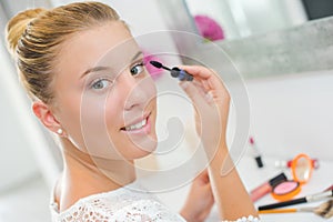 Woman applying mascara
