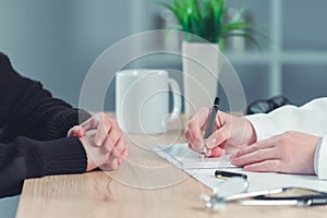 Woman applying for medical exam at female doctor`s office