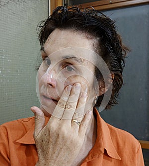 Woman Applying Moisturising Cream To Her Face. photo