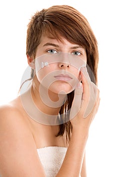 Woman applying moisturizer