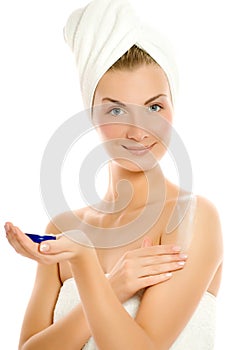 Woman applying moisturizer photo