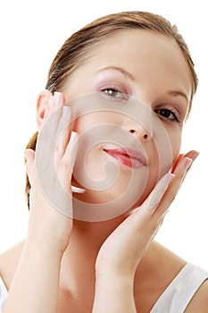 Woman applying moisturizer cream on face