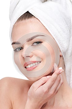 Woman applying moisturizer cream on face