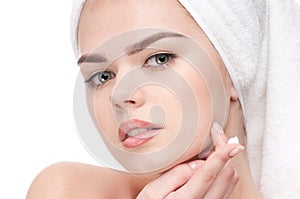 Woman applying moisturizer cream on face