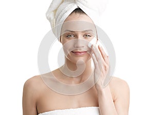 Woman applying moisturizer cream on face