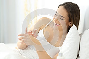 Woman applying moisturizer cream in hands photo