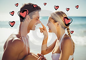 Woman applying moisturizer cream on mans nose at beach