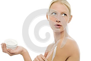 Woman applying moisturizing lotion on the body