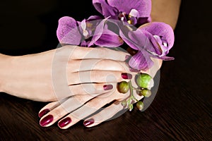 Woman applying nail varnish to finger nails