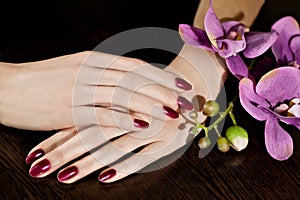 Woman applying nail varnish to finger nails