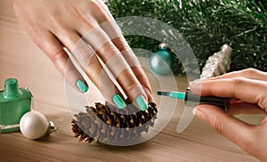 Woman applying nail varnish to finger nails