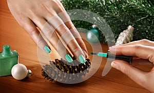 Woman applying nail varnish to finger nails