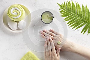 Woman applying natural scrub to her hand. hand massage, skin exfoliation.