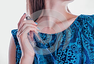 Woman applying perfume on her neck