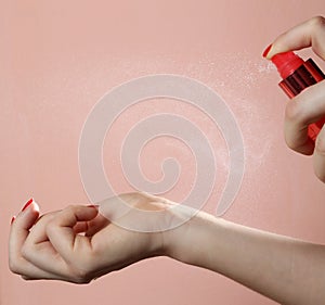 Woman applying perfume on her wrist
