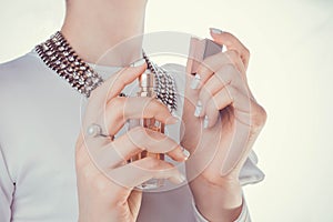 Woman applying perfume on her wrist