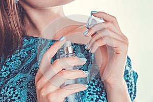 Woman applying perfume on her wrist