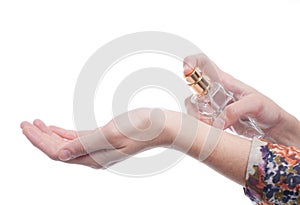 Woman applying perfume on her wrist, bright red pe