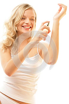 Woman applying perfume on wrist