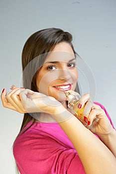 Woman applying perfurme on her wrist
