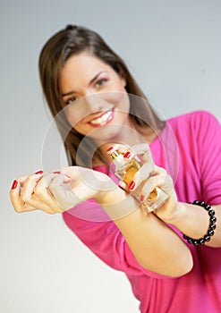 Woman applying perfurme on her wrist