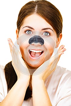 Woman applying pore strips on nose