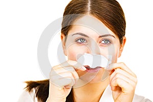 Woman applying pore strips on nose