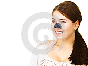 Woman applying pore strips on nose