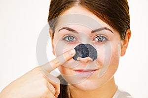 Woman applying pore strips on nose