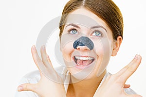 Woman applying pore strips on nose