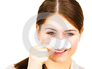 Woman applying pore strips on nose