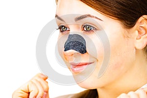 Woman applying pore strips on nose