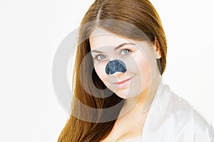 Woman applying pore strips on nose