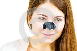 Woman applying pore strips on nose