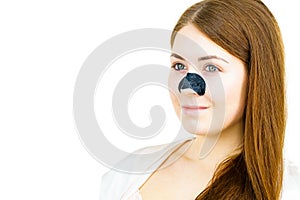 Woman applying pore strips on nose