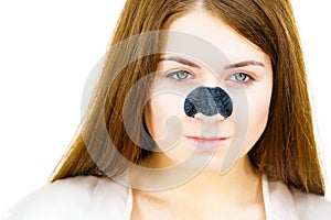 Woman applying pore strips on nose