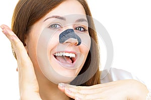 Woman applying pore strips on nose