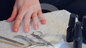 Woman is applying primer on nails before cover it shellac gel polish, closeup.