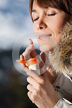 Woman applying protective cream in winter