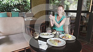 Woman applying sanitizer gel onto her hand before eating for protection against infectious virus, bacteria and germs